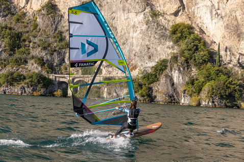 Fanatic Gecko Eco freeride windsurf board during windsurfing on Lake Garda with rocky cliffs
