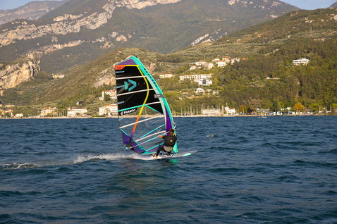 Fanatic Jag LTD windsurf board during windsurfing on Lake Garda with teal and purple sail