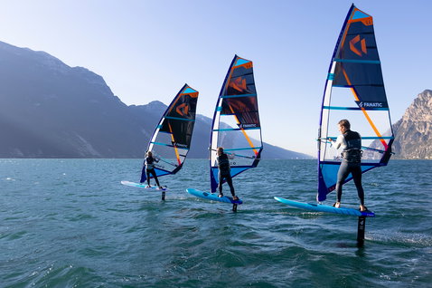 Fanatic Stingray Foil HRS windsurf foil board during wind foiling on an alpine lake with three riders