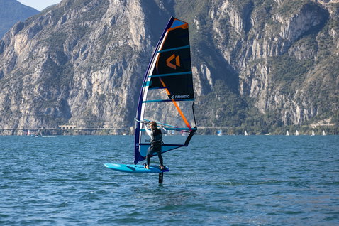 Fanatic Stingray Foil LTD windsurf foil board during foiling on an alpine lake with mountain backdrop