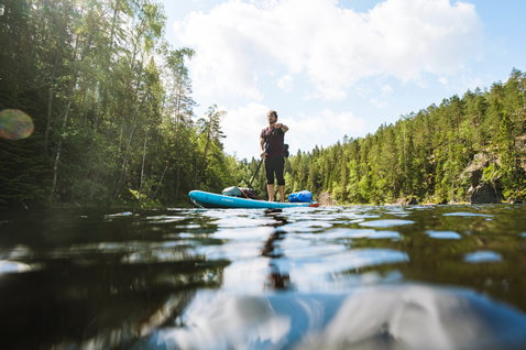 Duotone Ray Air inflatable touring SUP during paddleboarding on a forest lake in Finland