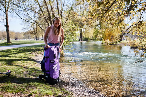 Duotone Diamond Air Touring Pocket SUP bag in purple during touring at a riverside park