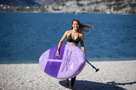 Duotone Diamond Air Touring Pocket inflatable SUP board 11'6" in violet during SUP touring at a mountain lake