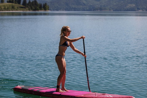 Fanatic Diamond Air Touring inflatable SUP board 11'6" in magenta during stand up paddling on an alpine lake