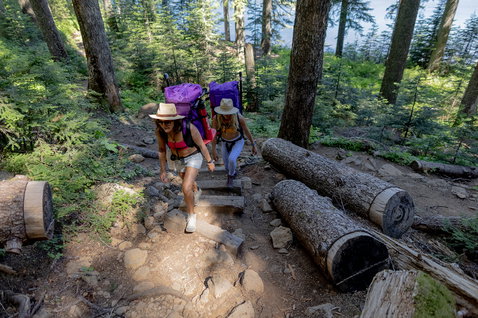 Duotone SUP Diamond Air Touring Pocket travel bag in purple carried hiking on a forest trail