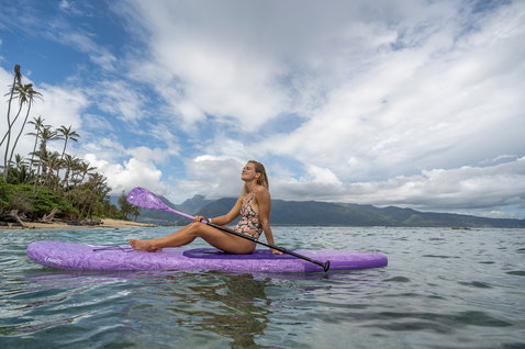 Fanatic Diamond Air Pocket inflatable SUP board 10'4" in purple during paddleboarding in a tropical bay