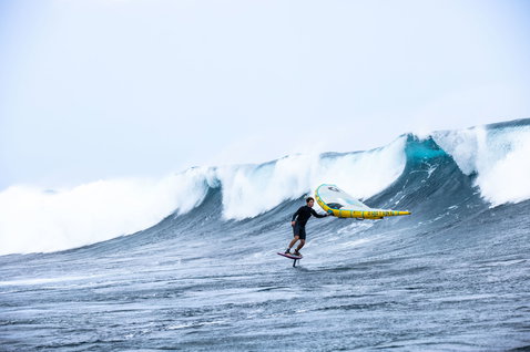 Duotone Unit D/LAB foil wing during wing foiling on the open ocean with large breaking wave