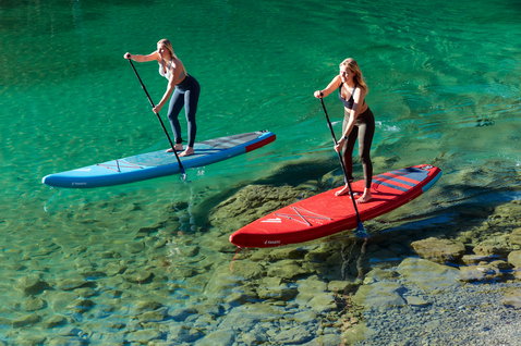 Fanatic Ray Air Pure inflatable touring SUP board during paddling on a turquoise alpine lake
