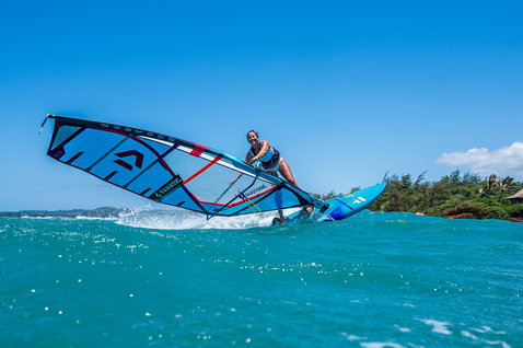 Fanatic FreeWave TE windsurf board during wave windsurfing on turquoise water in Maui in ocean blue