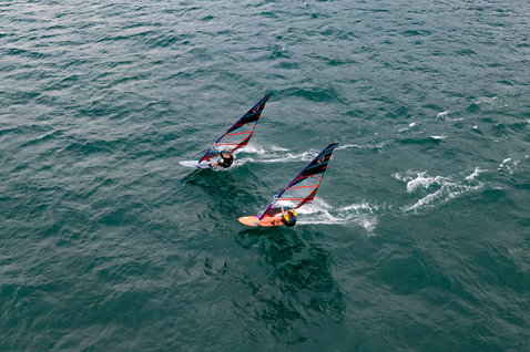 Fanatic Jag LTD slalom windsurf board during windsurfing on Lake Garda aerial view