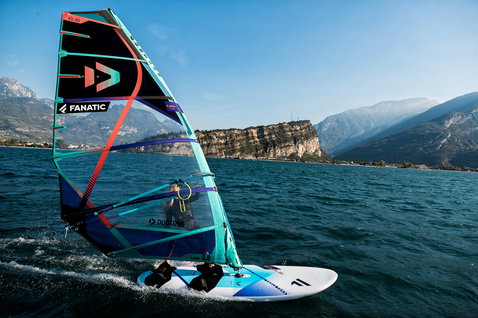Fanatic Eagle HRS freeride windsurf board during windsurfing on Lake Garda with alpine backdrop