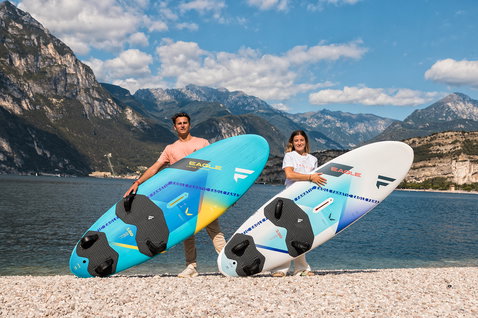 Fanatic Eagle freeride windsurf board 130L and 150L in aqua blue and white at lakeside