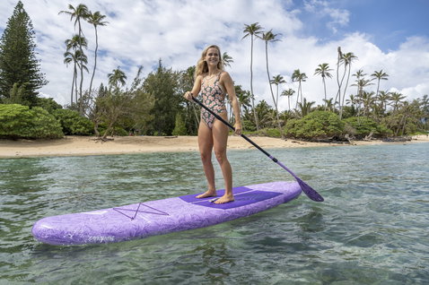 Fanatic Diamond Air Pocket inflatable SUP board 10'4" in lavender during stand-up paddling in a tropical lagoon