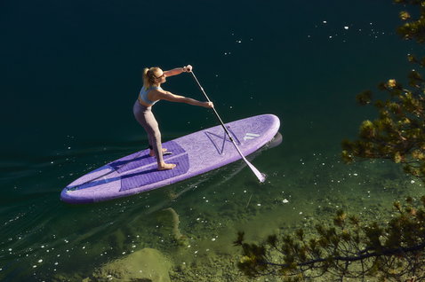 Fanatic Diamond Air Pocket inflatable SUP board 10'4" in purple during stand up paddling on an alpine lake