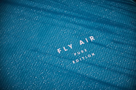 Duotone Fly Air Pure Edition inflatable SUP board deck detail in ocean blue with water droplets
