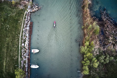 Fanatic Falcon Air Premium inflatable SUP raceboard during flat water paddling on a river aerial view