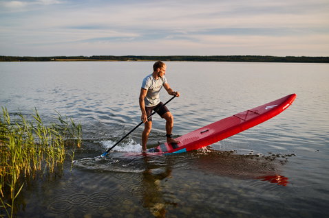 Duotone Ray Air aufblasbares Touring SUP Board beim Paddeln auf einem ruhigen See