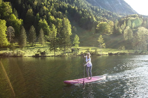 Duotone Diamond Air Touring inflatable SUP board 11'6" during stand-up paddling on a mountain lake