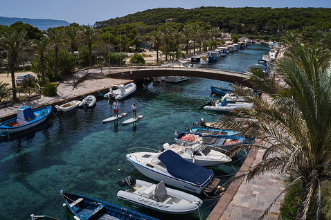 Fanatic Ray Air SLT iSUP during stand-up paddling in a Mediterranean marina, aerial view