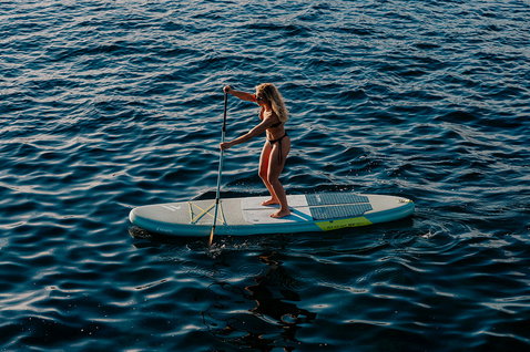 Fanatic Fly Air SLT inflatable SUP board during paddling on open ocean, aerial view