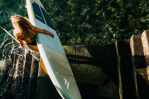 Fanatic Fly Air SLT inflatable SUP board during stand-up paddleboarding at a stone harbour