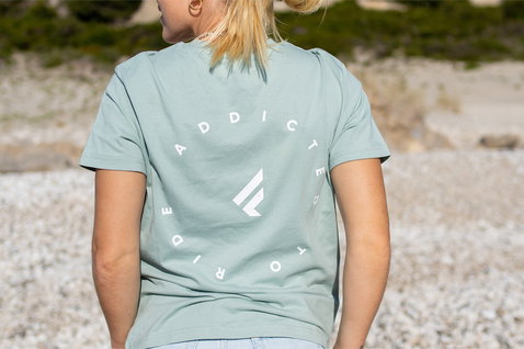Fanatic SUP unisex tee in sage green with back print worn at a pebble beach