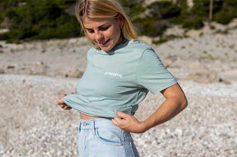 Fanatic SUP unisex tee in sage green worn at a pebble beach