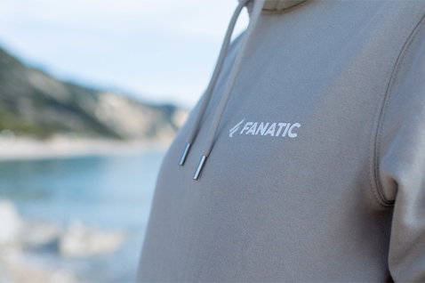 Fanatic SUP unisex hoodie in light taupe with Fanatic chest logo at coastal location
