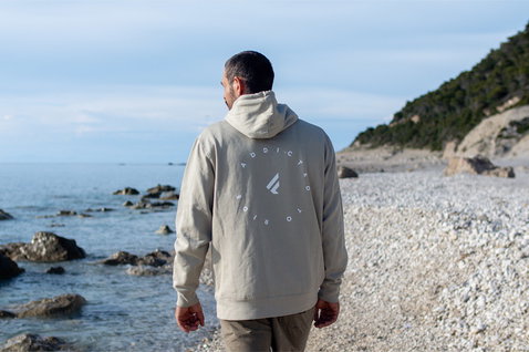 Fanatic SUP unisex hoodie in sand beige with Addicted to Ride back print at the coast