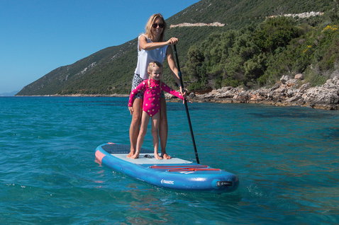 Fanatic Viper Air SLT inflatable SUP board during family paddling on calm turquoise water